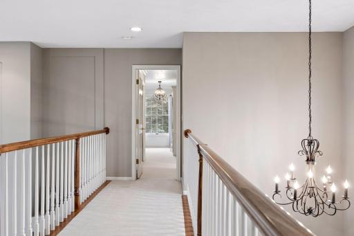 Cross the catwalk to the other side of the upper level to a second primary suite