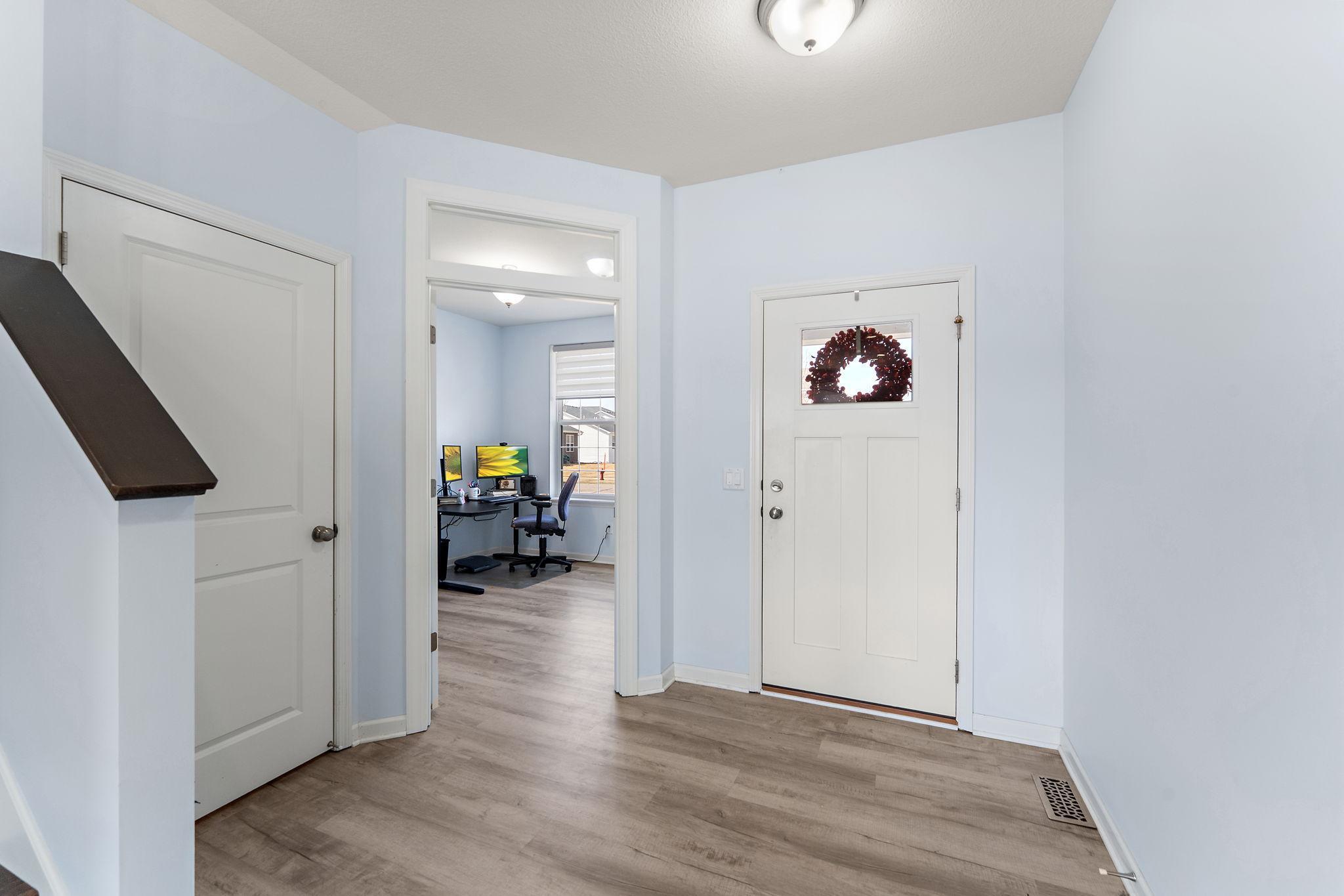 A bright and airy foyer welcomes you with fresh neutral paint and durable wide-plank flooring that flows seamlessly throughout the entire carpet-free main level.