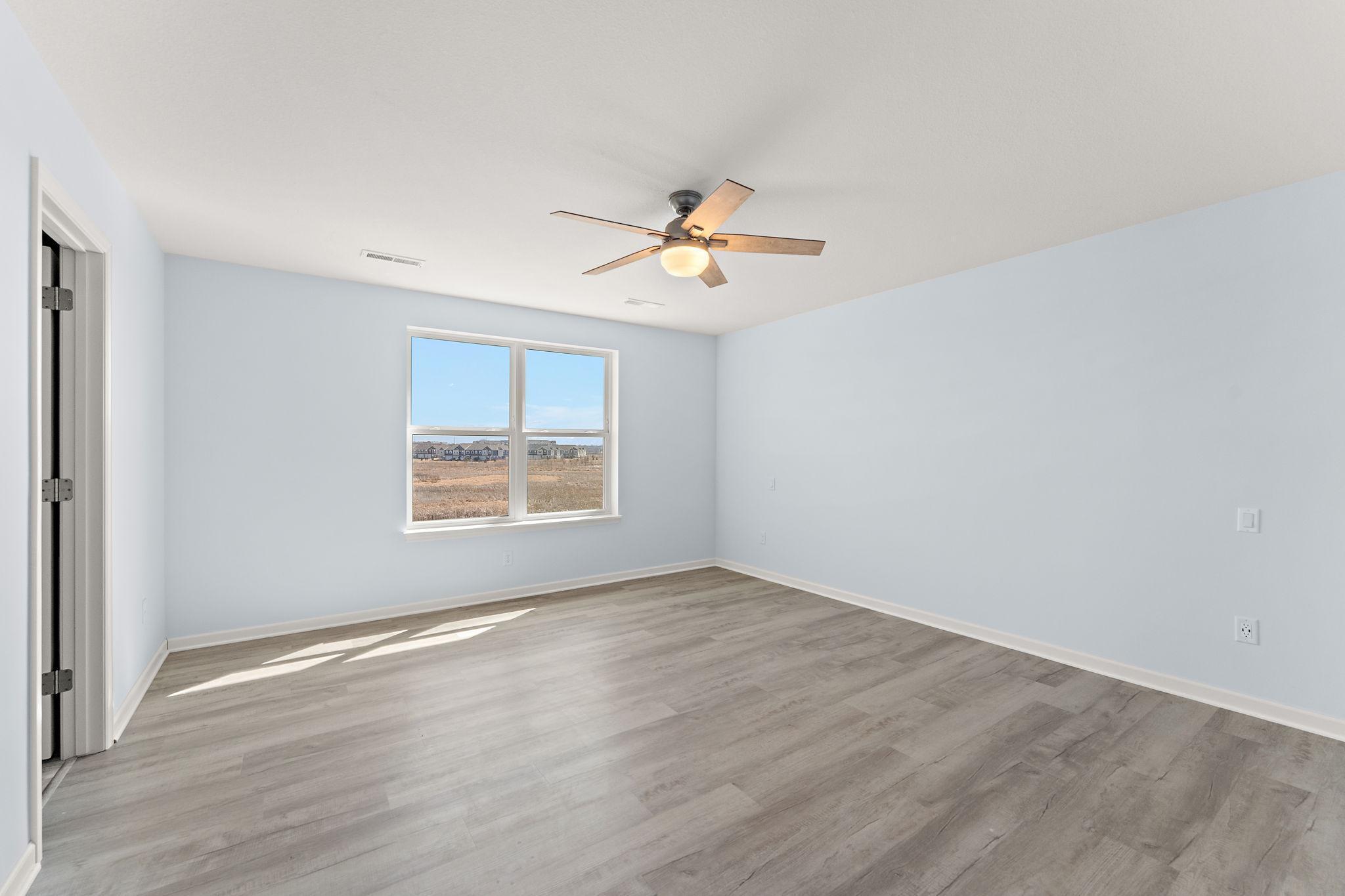 The spacious primary suite is a peaceful retreat, expansive windows with nature views, and a massive walk-in closet.