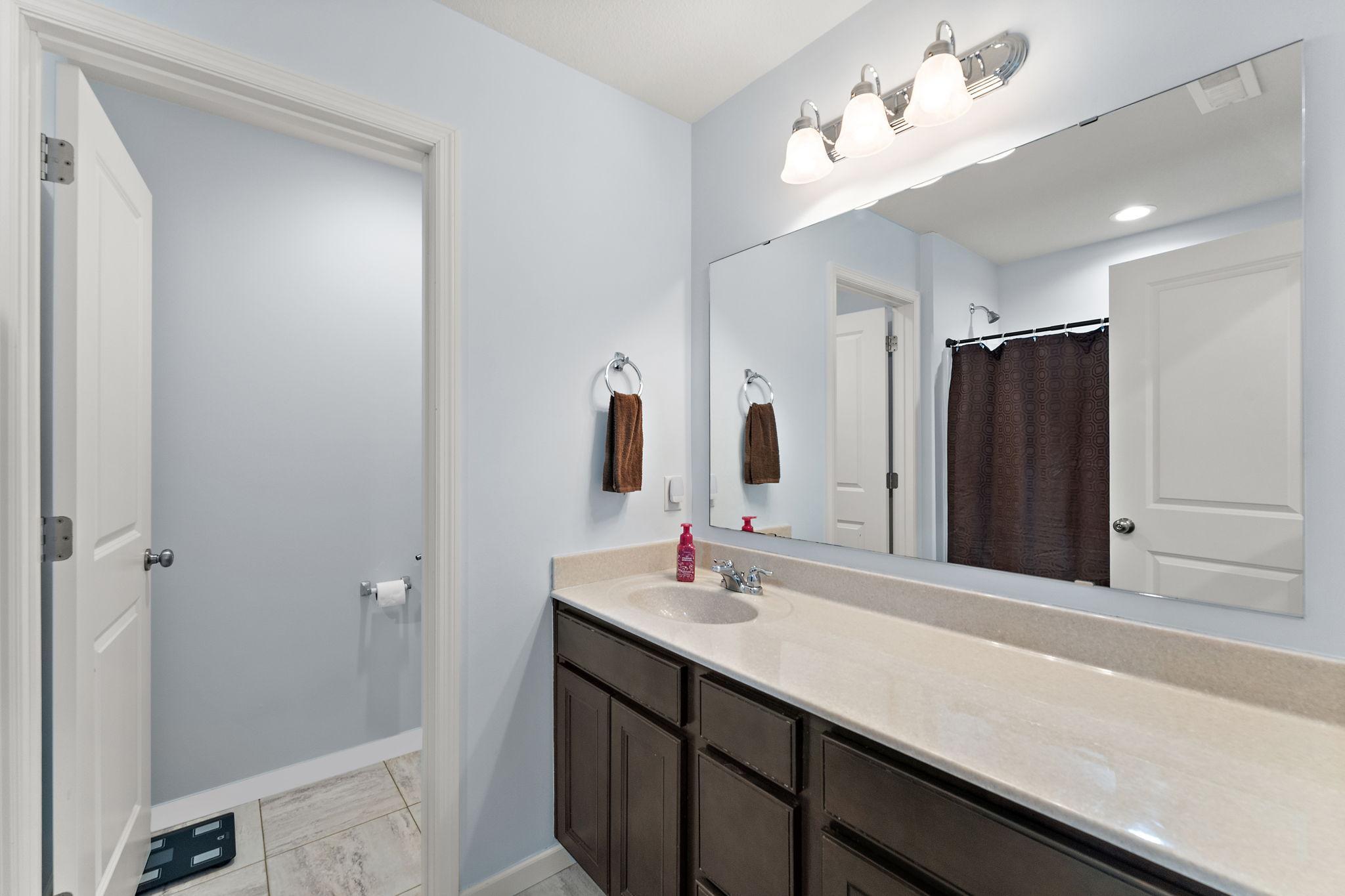 This bright and spacious shared bathroom serves the secondary bedrooms and loft with ease.