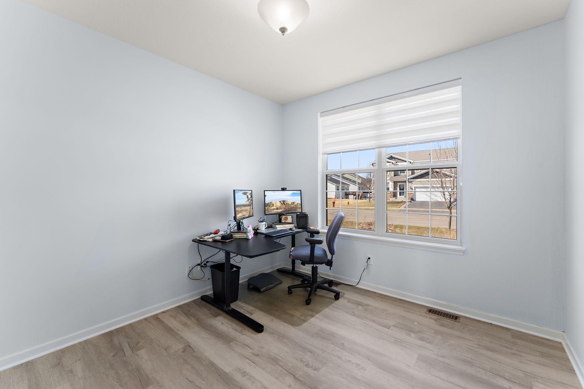 Featuring large windows and a quiet location away from the main living hub, it’s perfectly suited for a professional office, private hobby room, or a functional 4th bedroom.