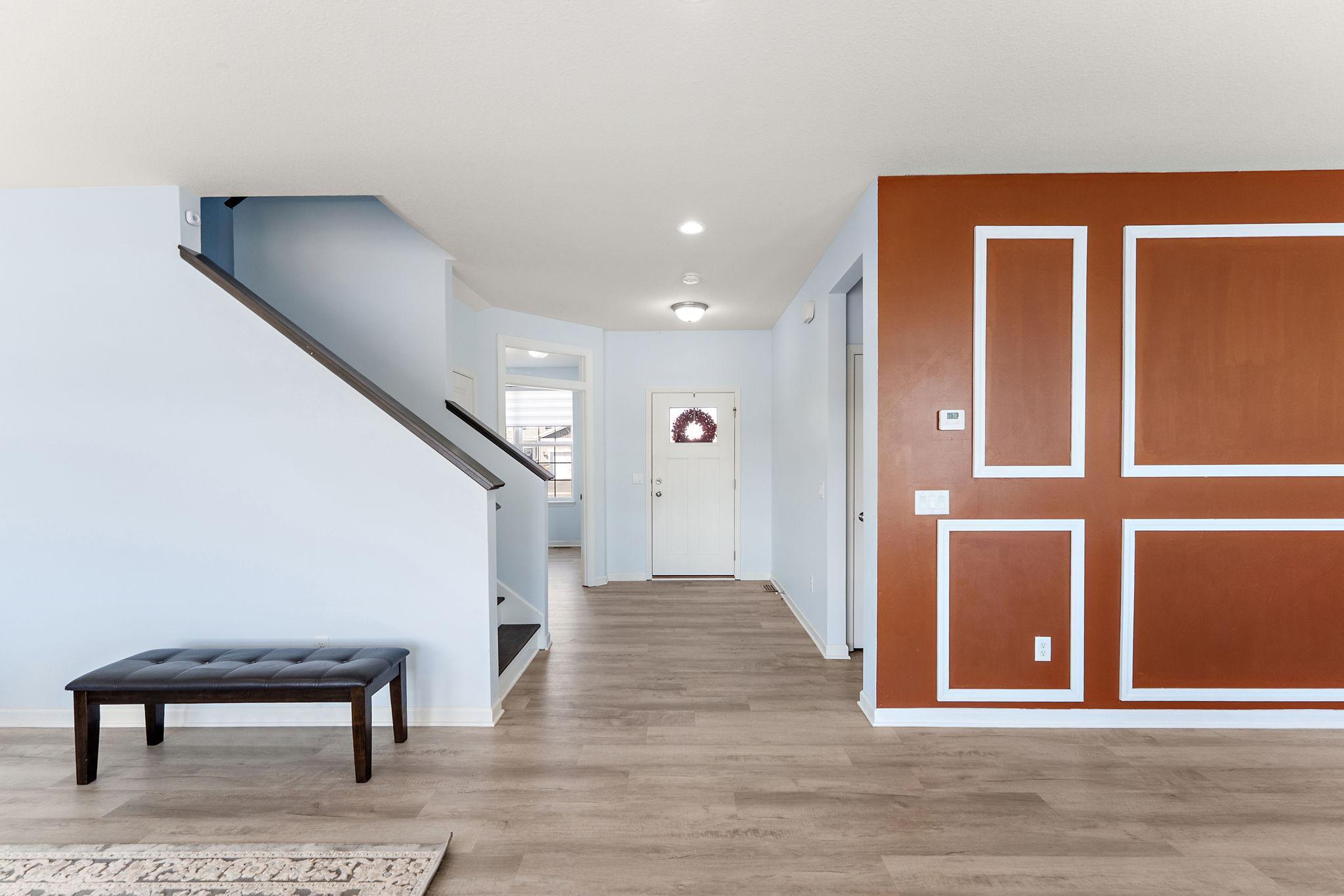 The open sightlines draw you into the heart of the home, showcasing the fresh, neutral paint palette and the carpet-free main level that makes for a clean and seamless living experience.