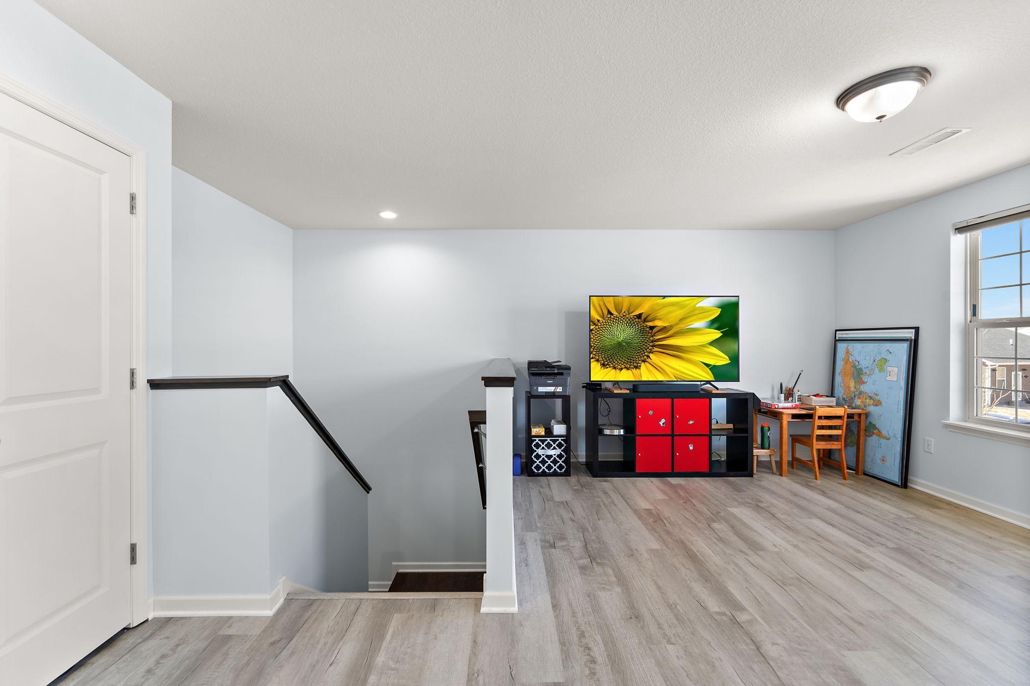 A versatile second-floor loft provides the perfect secondary living space, media room, or play area. Positioned centrally between the bedrooms for ultimate convenience.