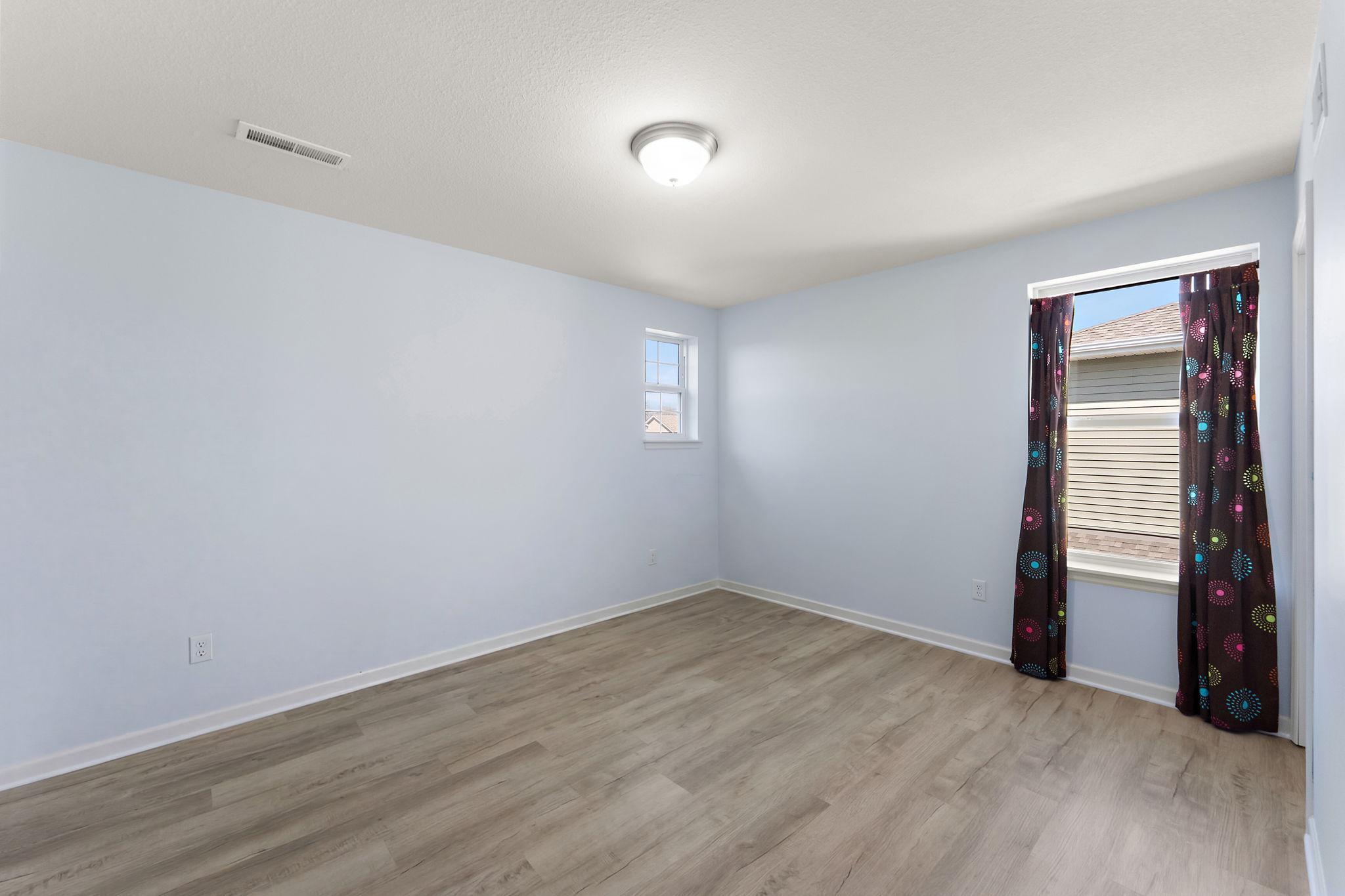 Another bright and spacious bedroom, perfect for family or guests, complete with a walk-in closet and easy access to the full upper-level bath.