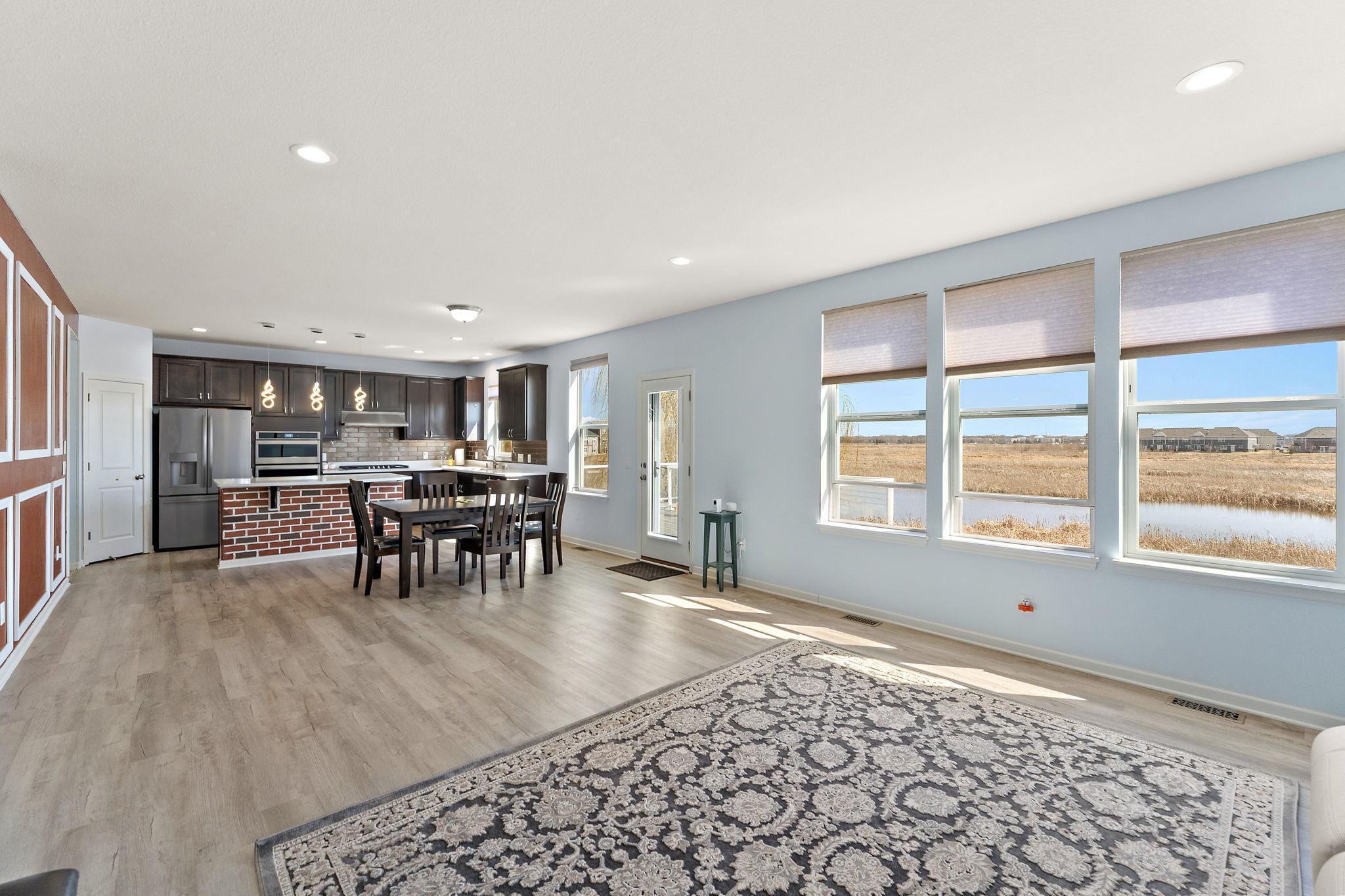Stunning panoramic views of the protected wetlands through a wall of windows. This space captures the "nature retreat" feel while maintaining a modern, clean aesthetic.
