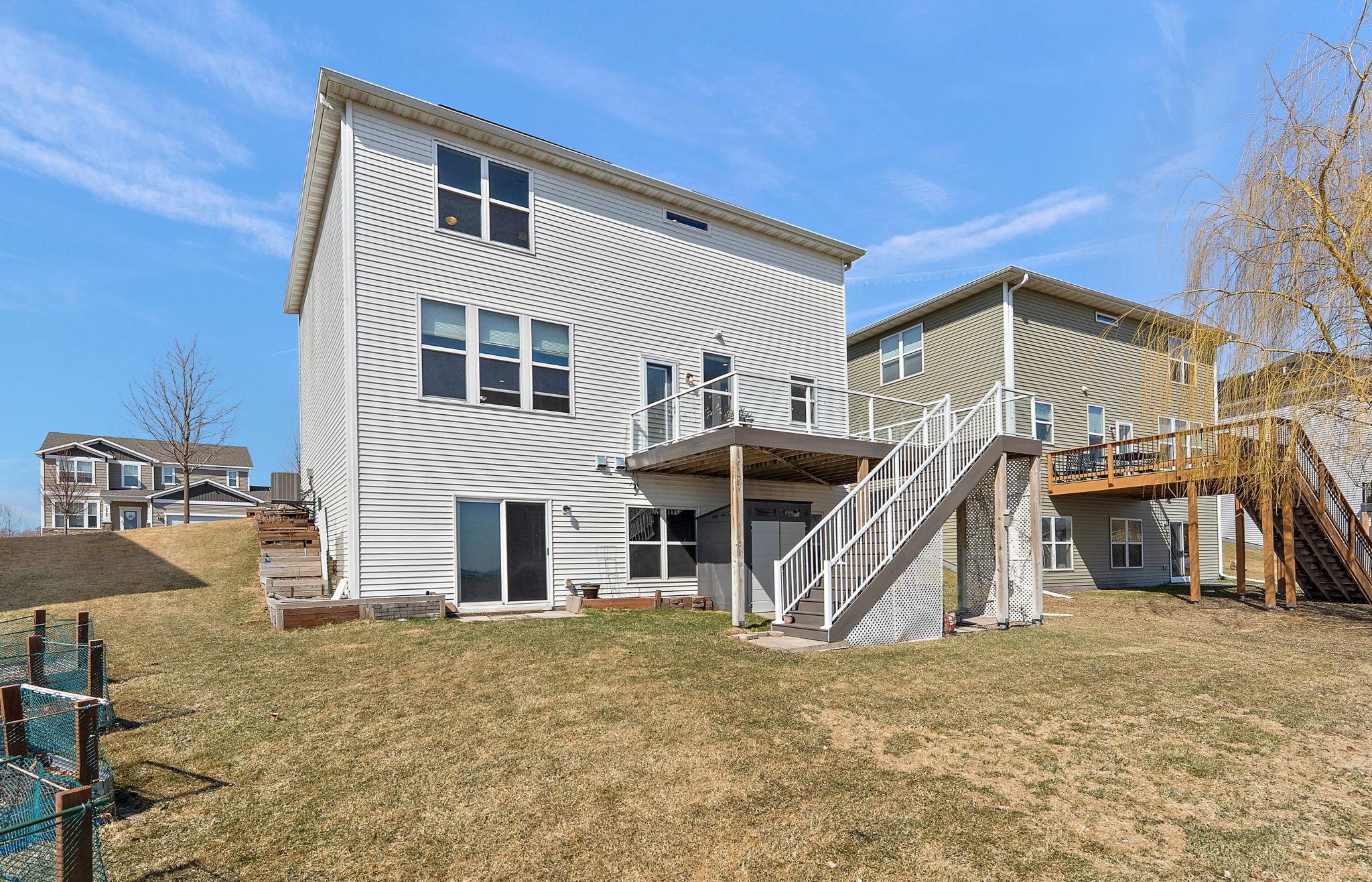This expansive, maintenance-free composite deck offers a private, elevated vantage point overlooking a protected nature preserve and tranquil pond.