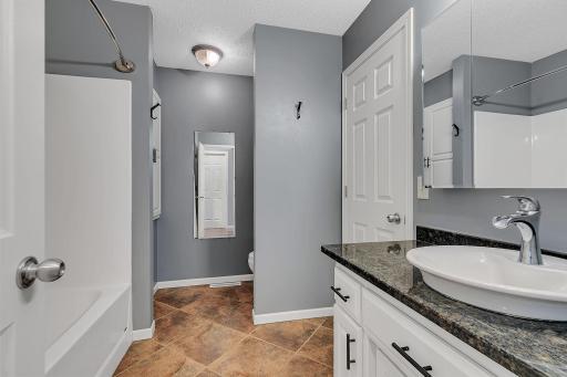Main floor full bath & vanity with granite top