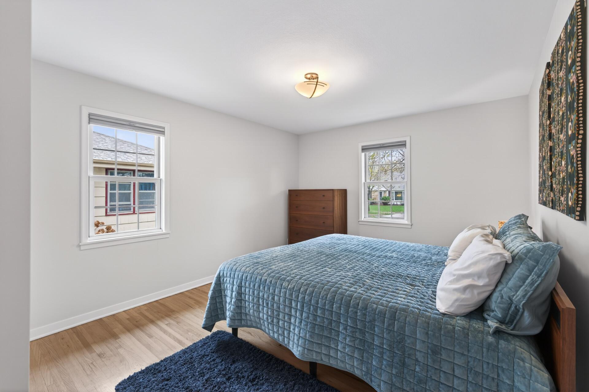 Main level primary bedroom that is freshly painted and bright and airy