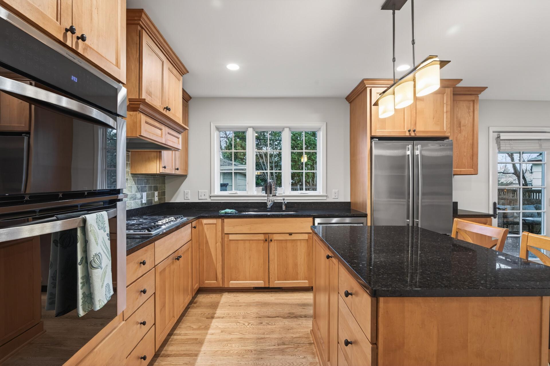 Bright, open kitchen with granite countertops and top of the line appliances