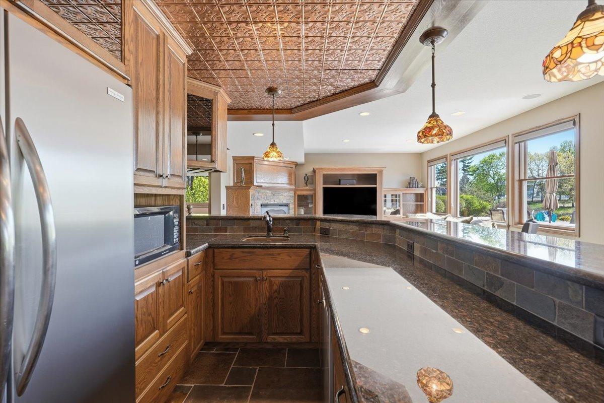 Lower level wet bar with full size fridge.