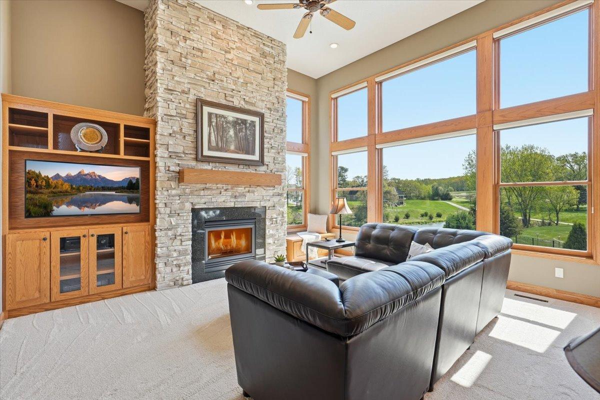 Floor to ceiling windows and a stunning stone fireplace.