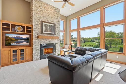 Floor to ceiling windows and a stunning stone fireplace.