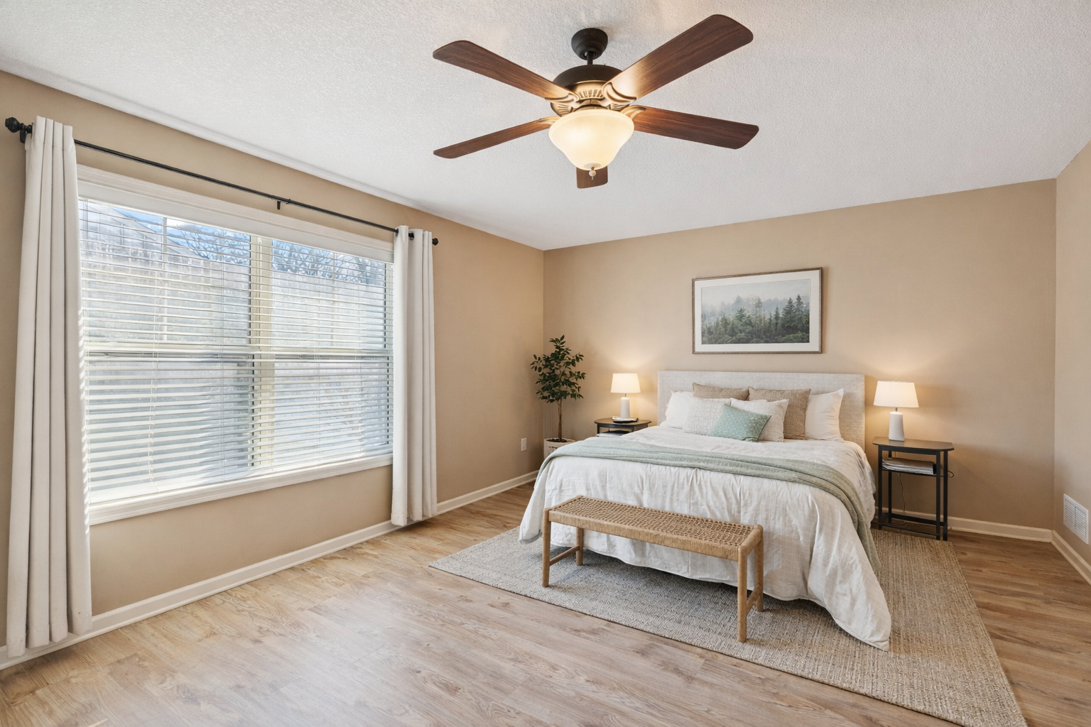 Primary bedroom is bright and serene. Primary bedroom offers a large walk in closet with an upgraded closet system. Room has been virtually staged.