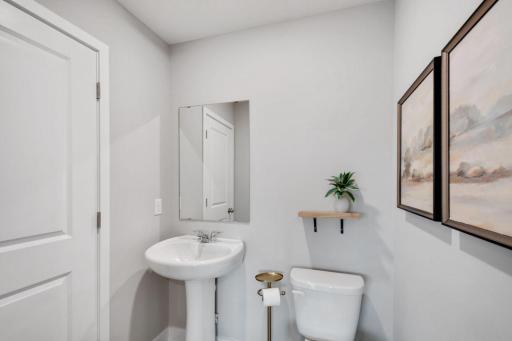Convenient half bath situated on the main level. Photo is of model home. Colors and options may vary. Ask Sales Agent for details.
