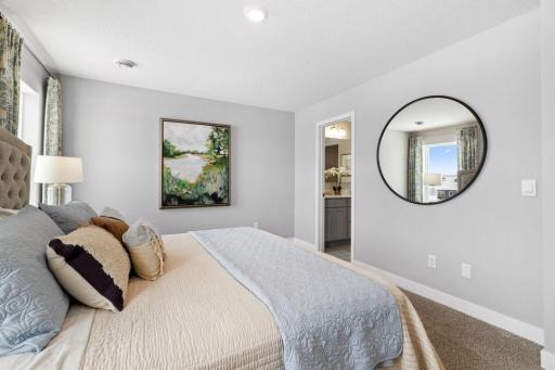 There's immediate access to primary bathroom featuring dual sinks and a large shower. Photo is of Model home. Colors and options may vary. Ask Sales Agent for details.