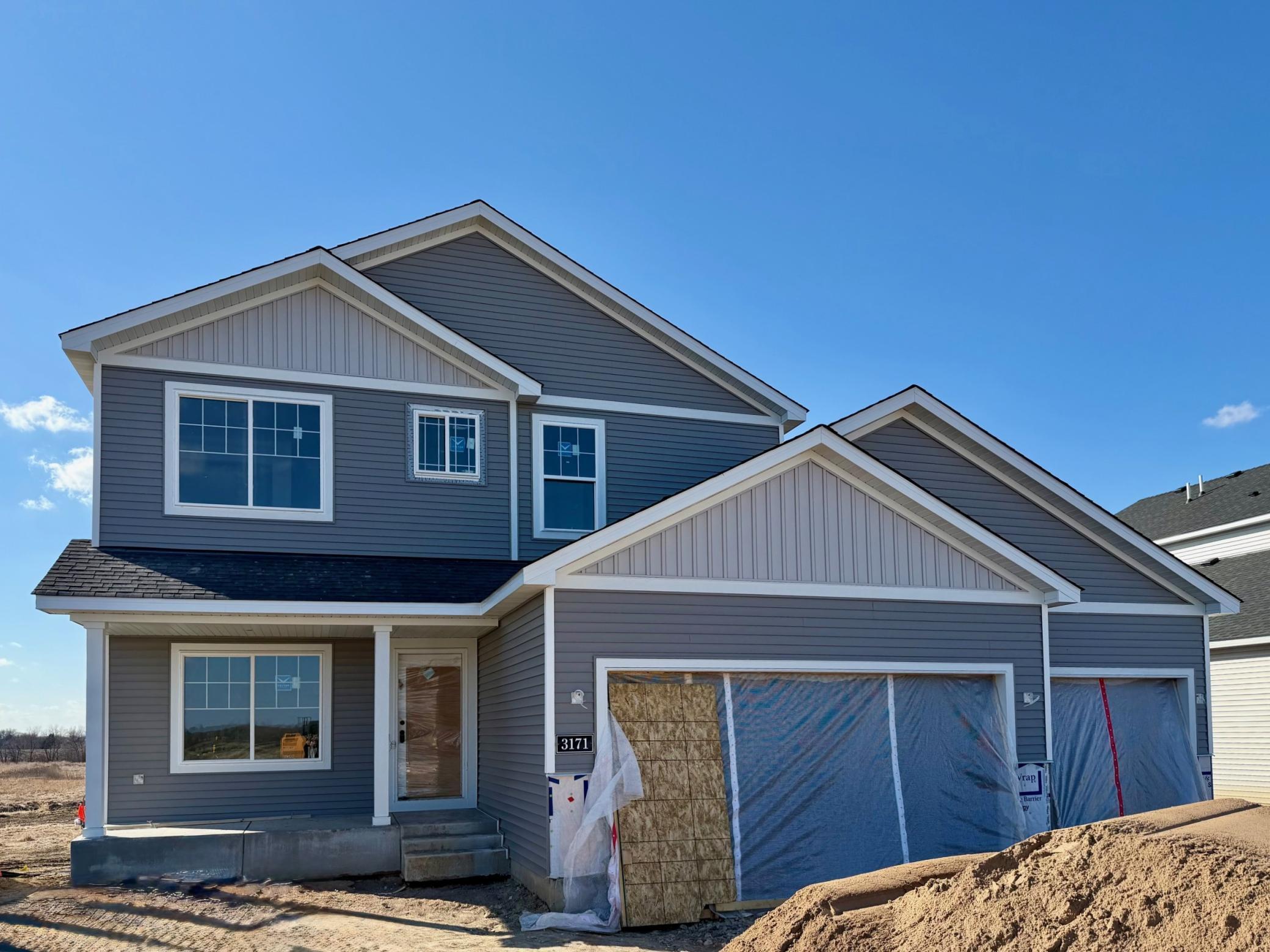3171 Jandura Ave NE- Photo of actual home under construction offering an estimated June move-in! Stone accents will be installed & concrete garage floor poured soon. Sod, Irrigation System, and Front Plantings included.