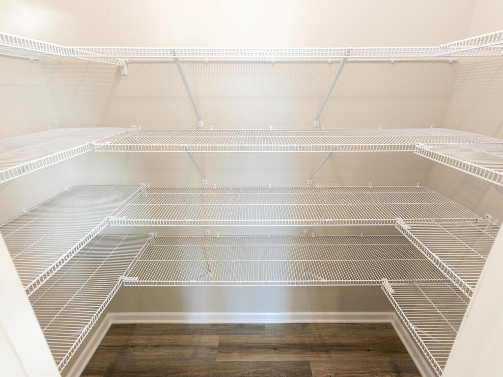 PHOTO OF A DIFFERENT HOME WITH SIMILAR PLAN. FINISHES MAY VARY. Kitchen Walk-in Pantry features shelving on three walls.