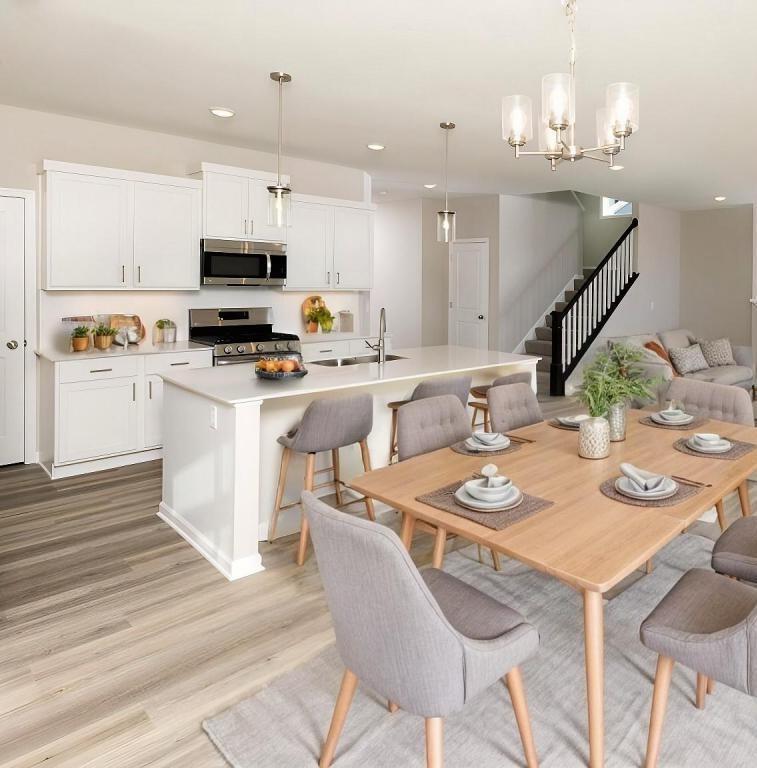 VIRTUALLY STAGED PHOTO OF A DIFFERENT HOME WITH SIMILAR PLAN. FINISHES WILL VARY. Dining Room/Kitchen.