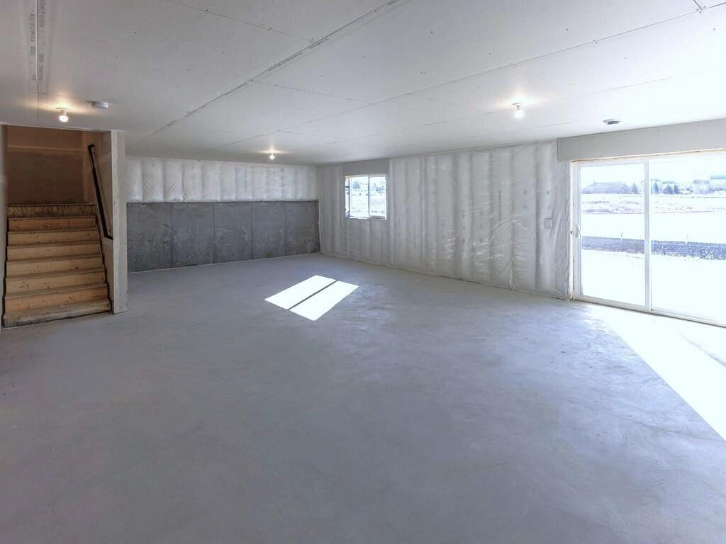 PHOTO OF A DIFFERENT HOME WITH SIMILAR PLAN. Unfinished Walkout Lower Level ready for future finish including future family room, bedroom 5, and bathroom 4.