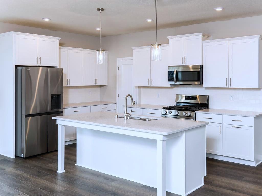 PHOTO OF A DIFFERENT HOME WITH SIMILAR PLAN. FINISHES MAY VARY.