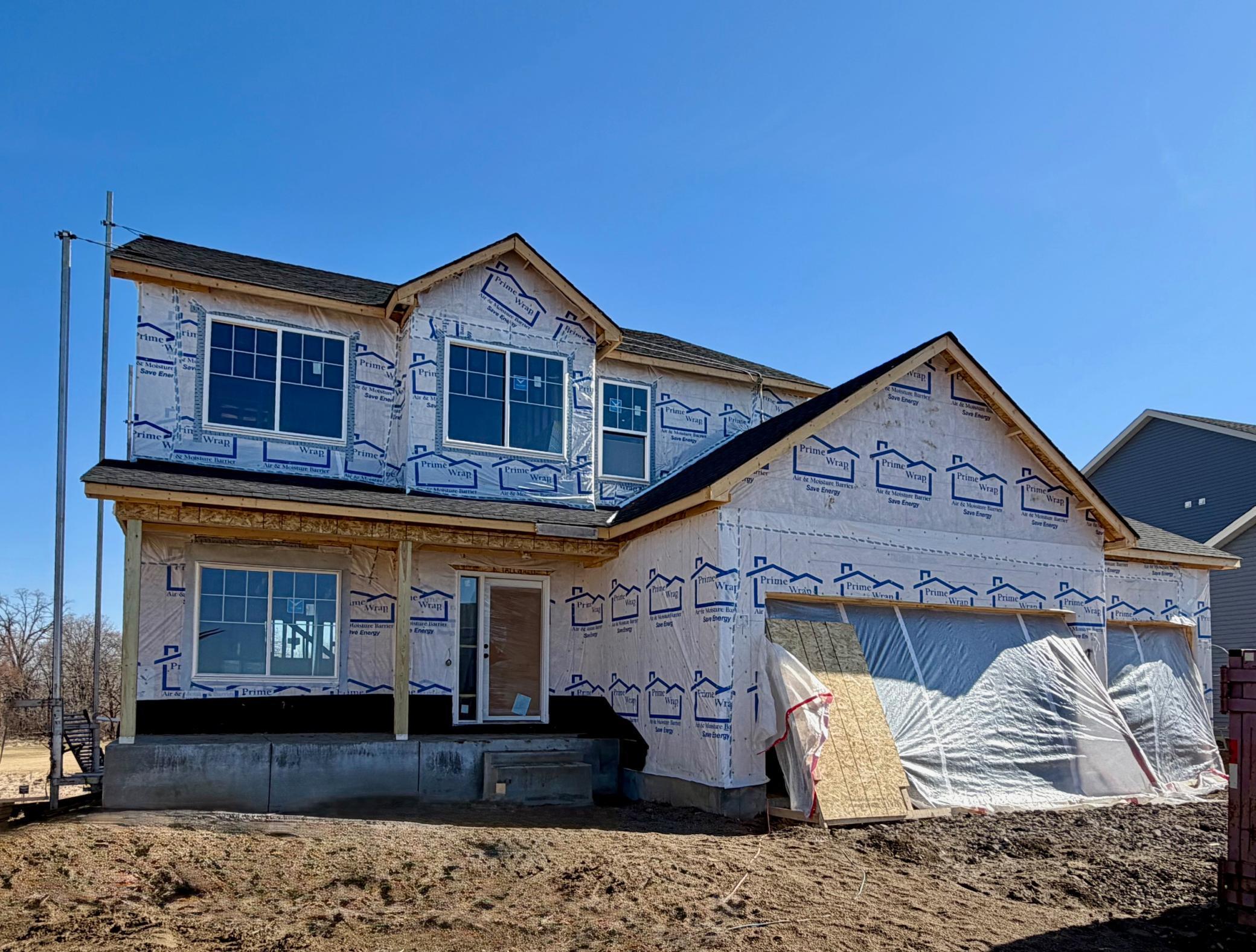 9686 32nd St NE- Photo of actual home under construction offering an estimated June Move-in! Sod, Irrigation System, and Front Plantings included. Siding installation will be completed and concrete garage floor poured soon.