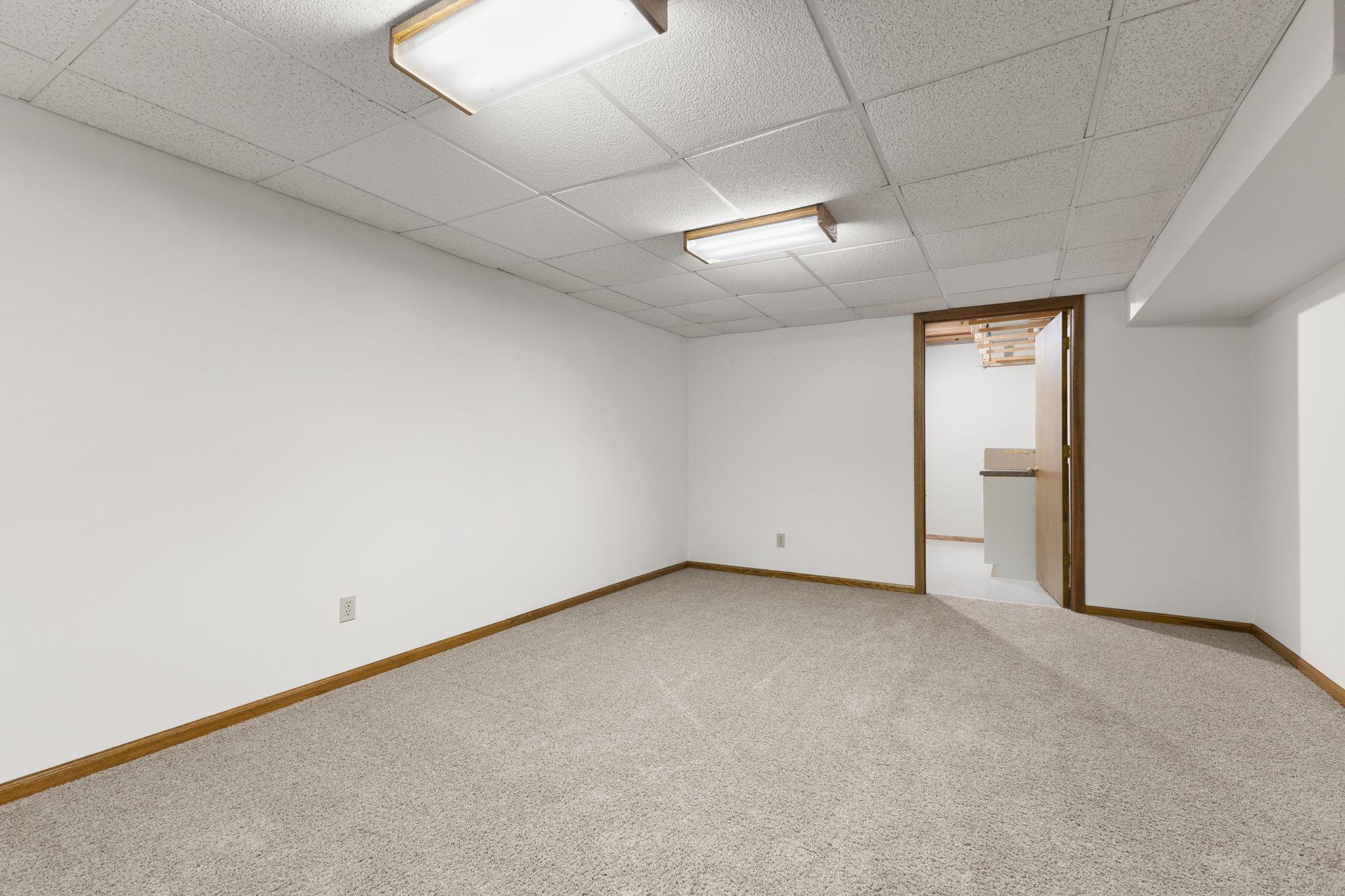And there is more! Additional finished space in the lower level to suit all your needs. Exercise room, gaming room, family room, let your imagination decide! There is a room beyond this that could serve as a perfect hobby room.