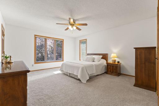 Primary bedroom with neutral walls & flooring and tons of space!