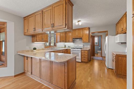 Abundance of storage with quality cabinetry, beautiful granite counters with expansive counter surface plus under cabinet lighting offer a well designed and functional space.