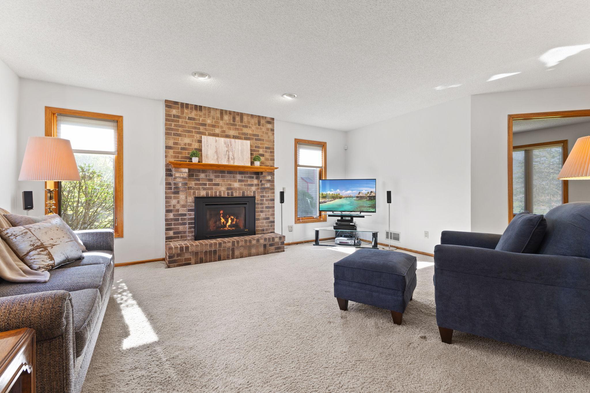 The sun filled living space with neutral finishes and a beautiful brick gas fireplace to conveniently cozy up the room whenever you choose.