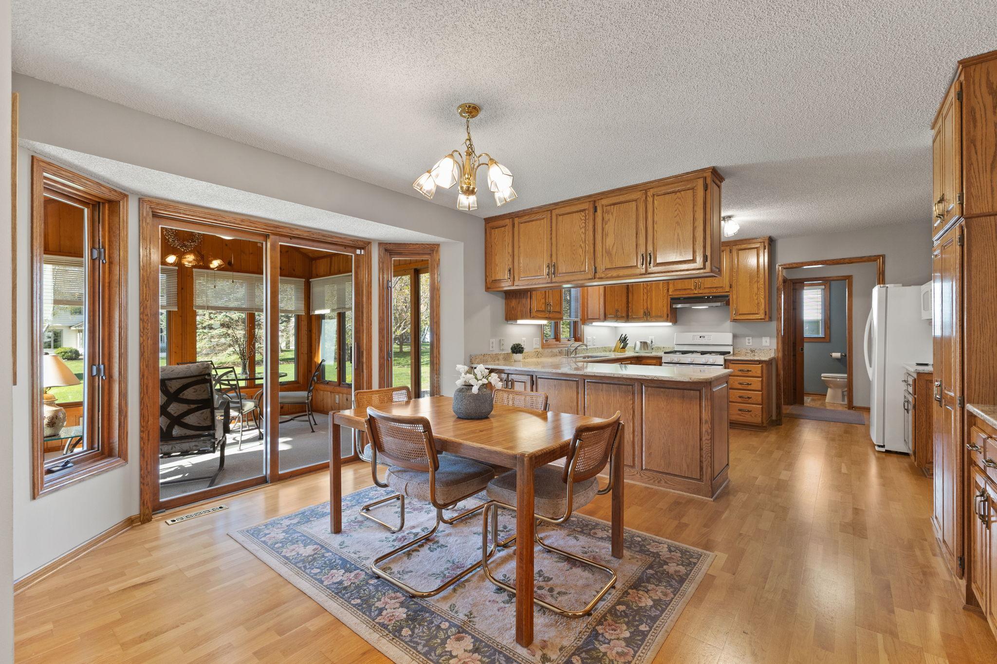 Casual second dining area which is ideal for busy families! Get a sneak peek into the sun room for additional living space.