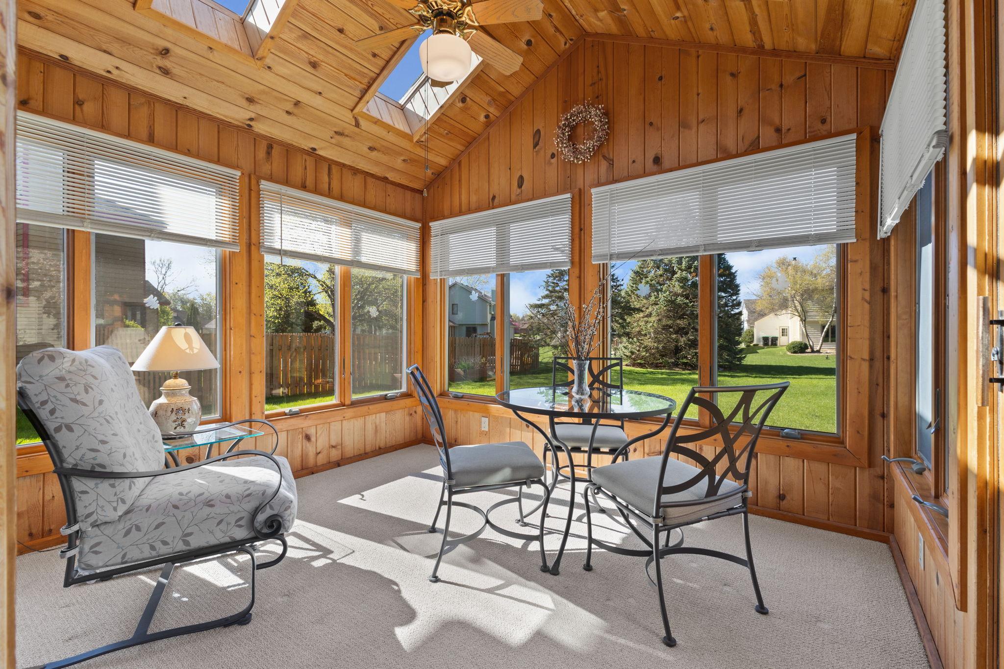 This will likely be your favorite room! Enjoy morning coffee or casual dinners in this fabulous sun filled 3 season porch. Warm rustic pine, skylights, endless windows (with blinds) & a ceiling fan offer a highly desirable retreat.