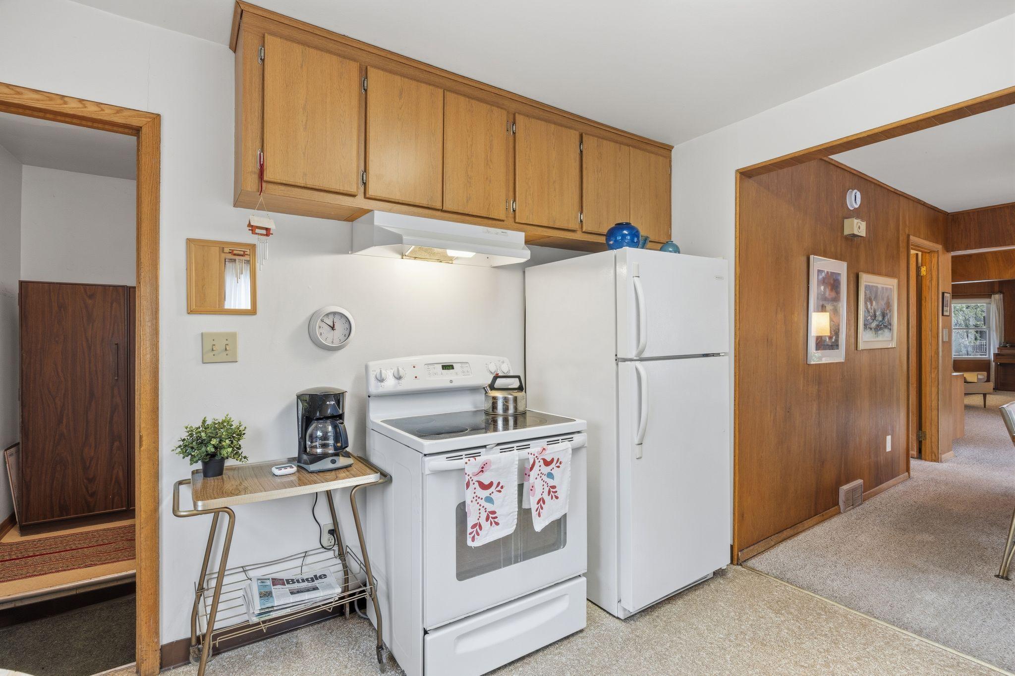 The kitchen layout is rounded out by the stove and refrigerator, positioned for a practical and efficient workspace.
