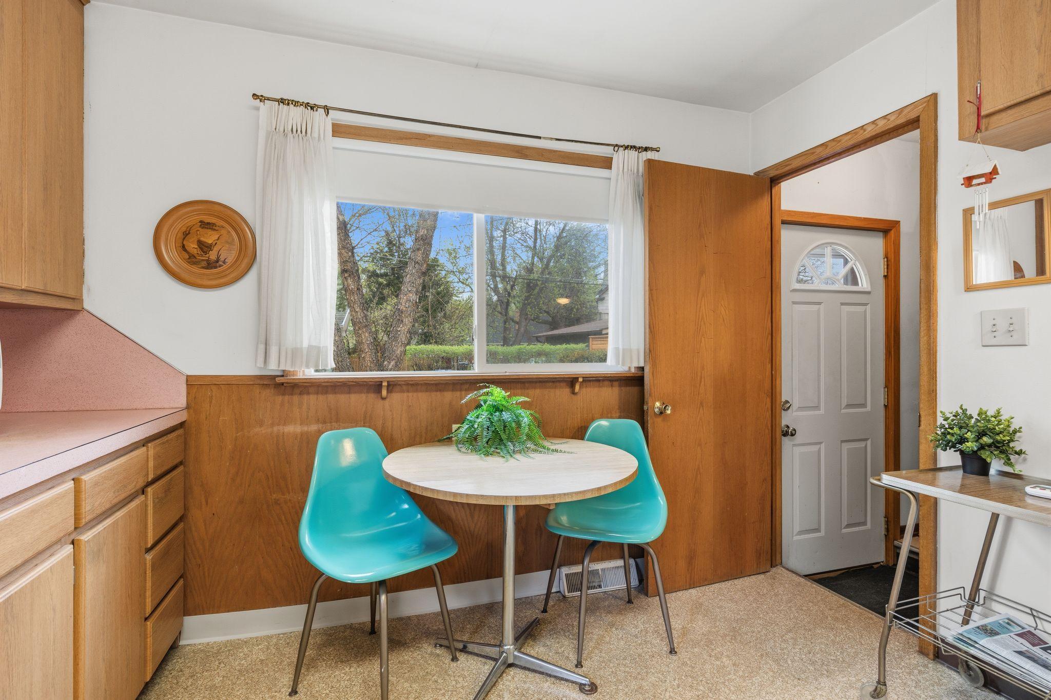This view shows the clear passage through the kitchen toward the back door and basement stairs. It’s a high-traffic area designed to keep the home’s main level connected and accessible.