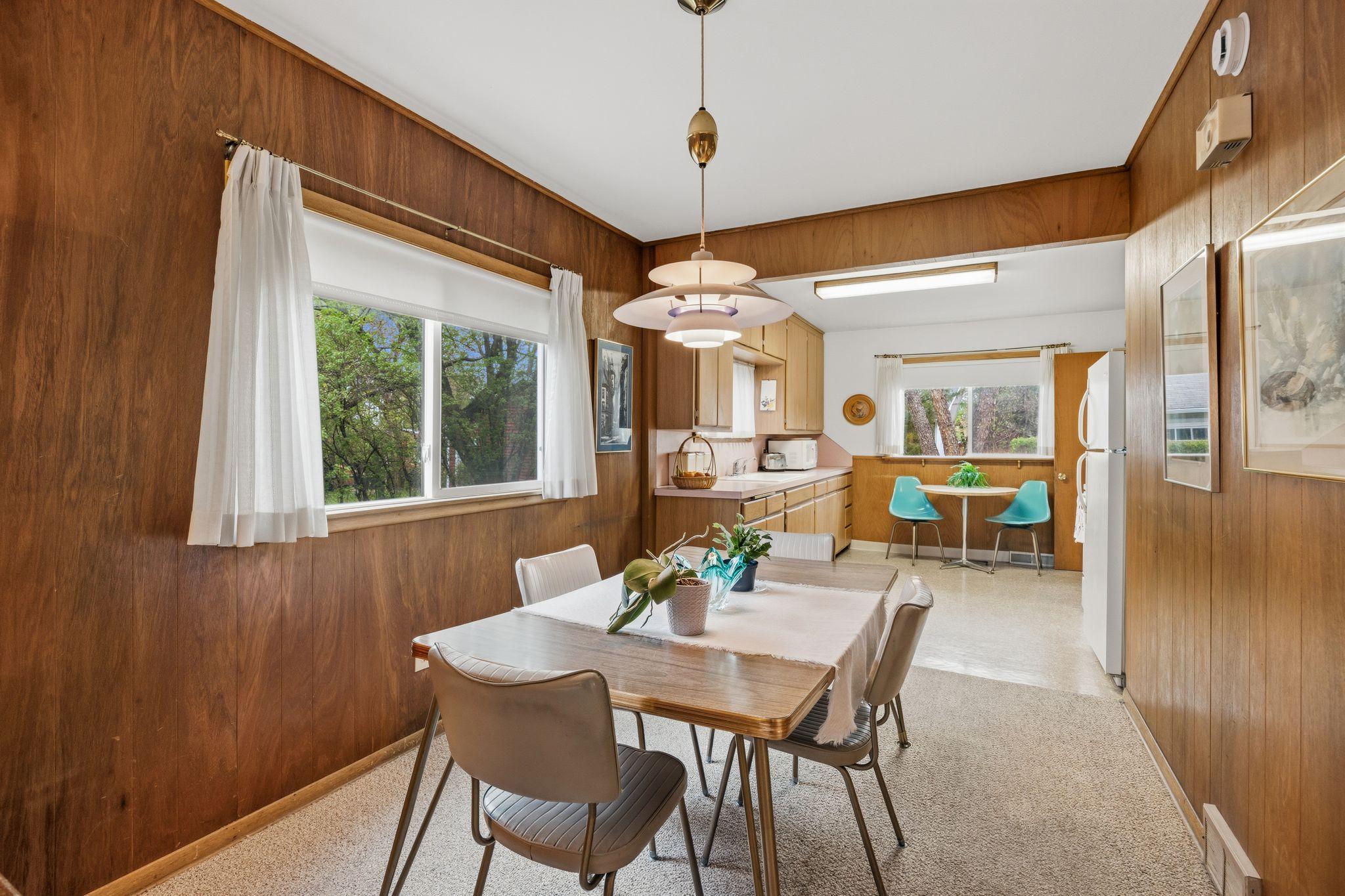 Positioned between the sitting room and kitchen, this open dining area creates a natural flow for hosting and daily meals. A large window offers a clear view of the backyard, bringing in plenty of natural light.