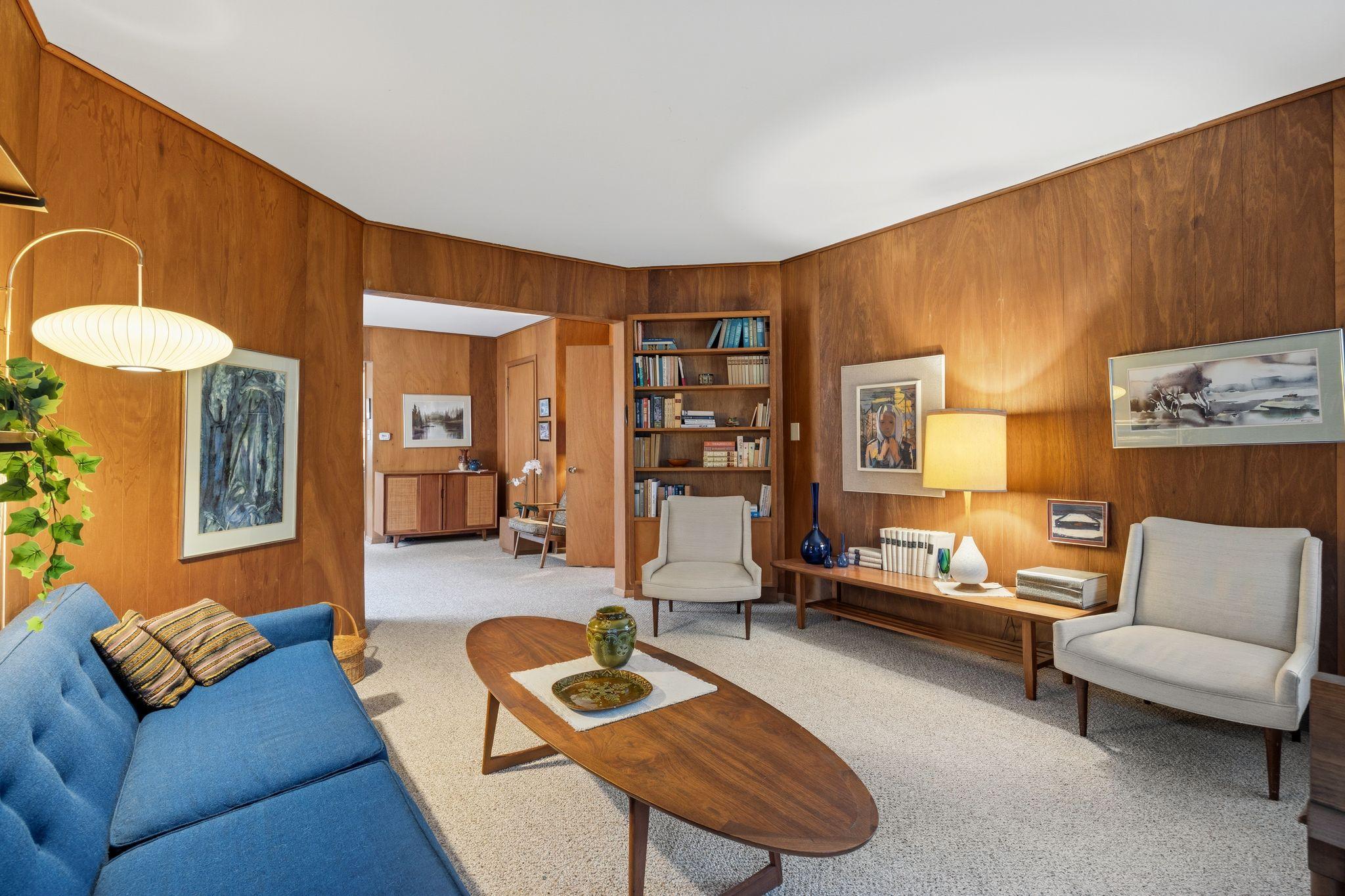 The living room flows naturally into a cozy sitting room, highlighting an open layout that's ideal for hosting.