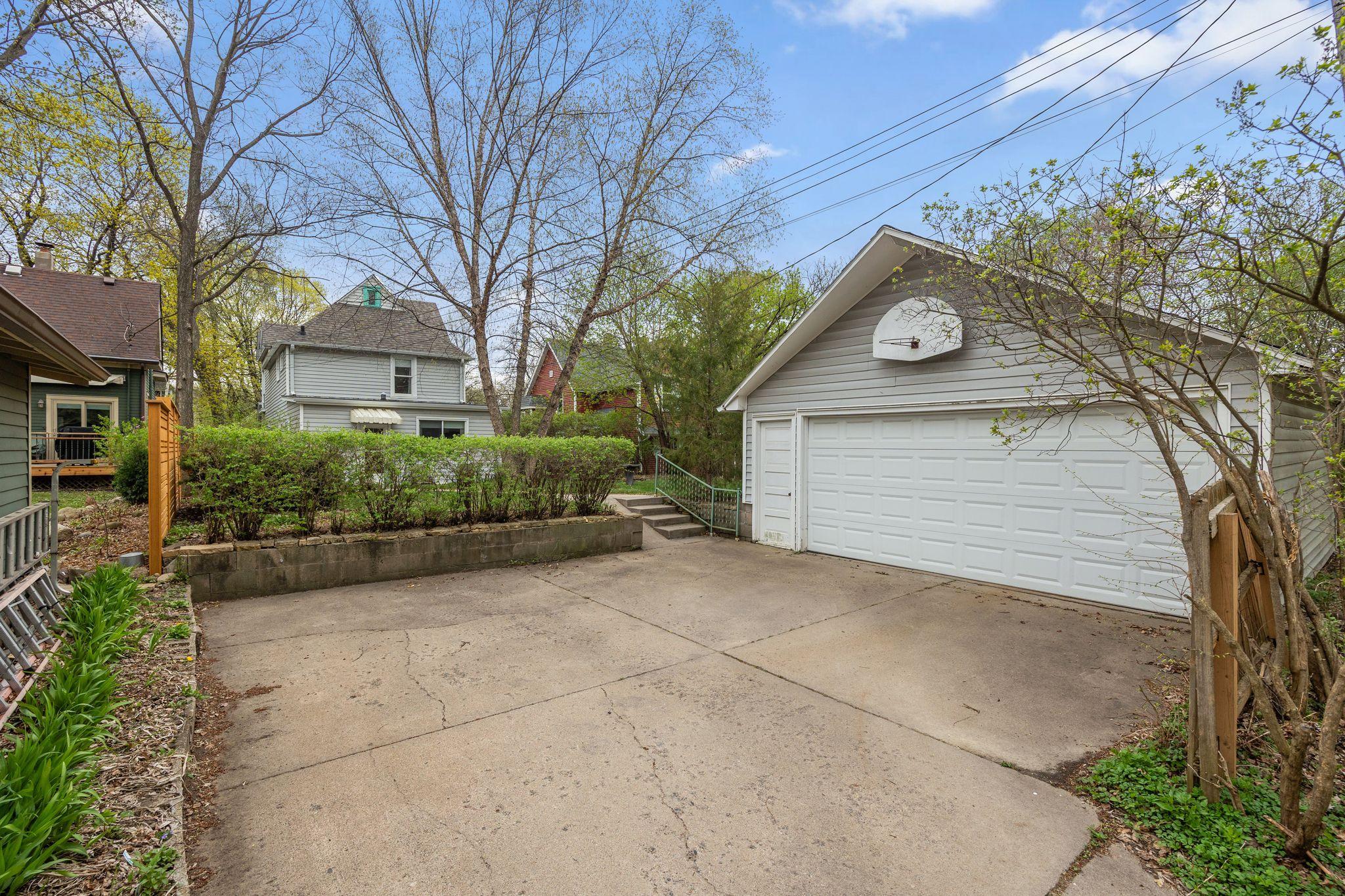 View of the parking behind the house and 2 car garage