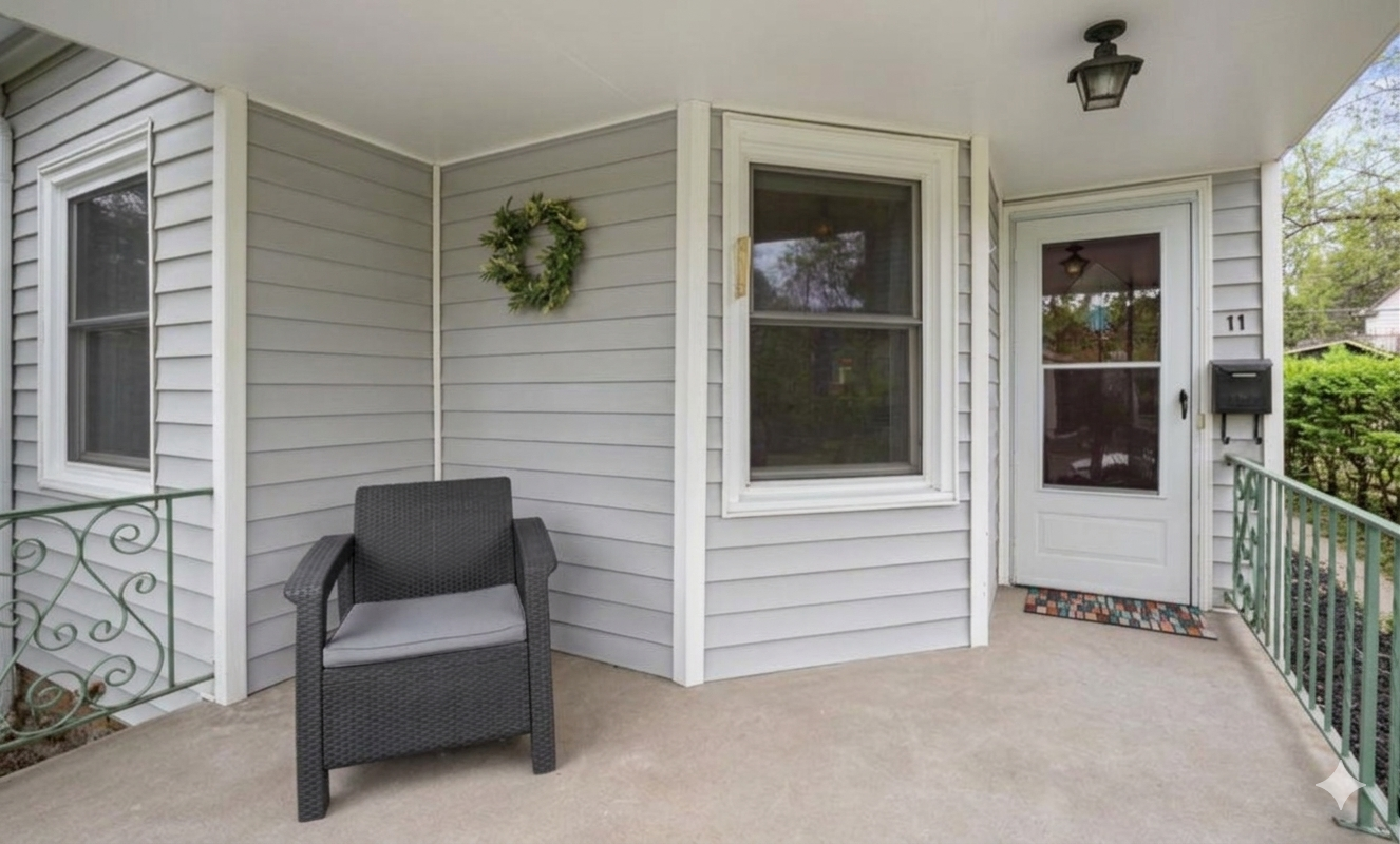 Enjoy quiet mornings on this shaded front porch that offers a comfortable spot for coffee.