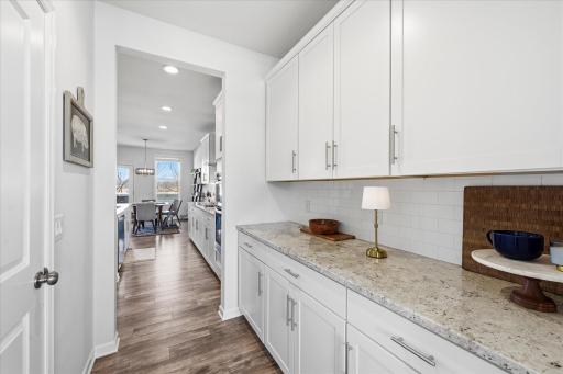 The workstation enables preparation without the mess in the kitchen. This home offers so much storage. In addition to the Butler's area, there is a walk in pantry.