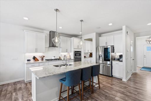 You're sure to love the Chef's kitchen with a gas cooktop, double wall ovens, smart fridge, butler's pantry, coffee bar & Granite counters. Notice all of the natural light?