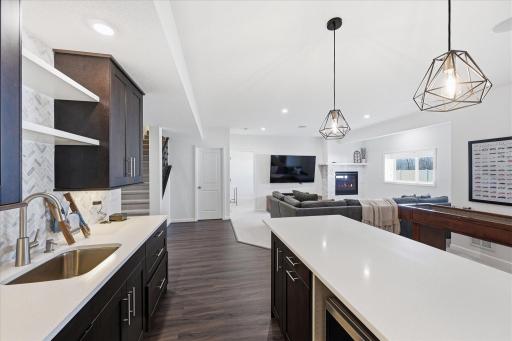 Stainless appliances, and modern pendant lighting create a showcase for this gathering area.
