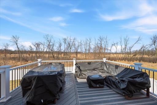 The deck creates a nice extended summer living space. The property extends beyond the Vinyl privacy fenced yard.
