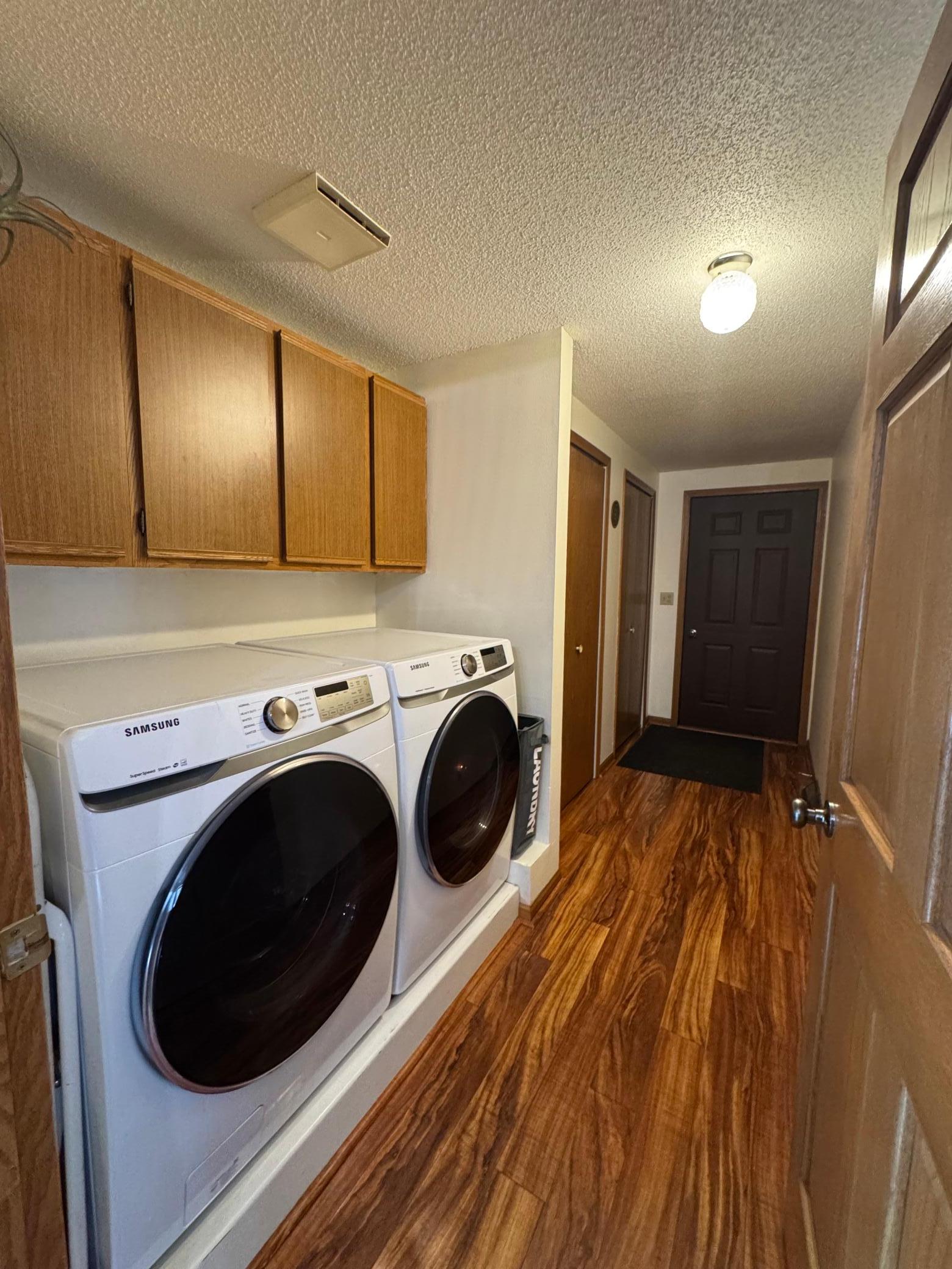 Hallway to Attached Garage with Laundry