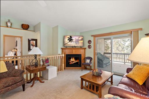 Gas fireplace in the living room and access to covered deck