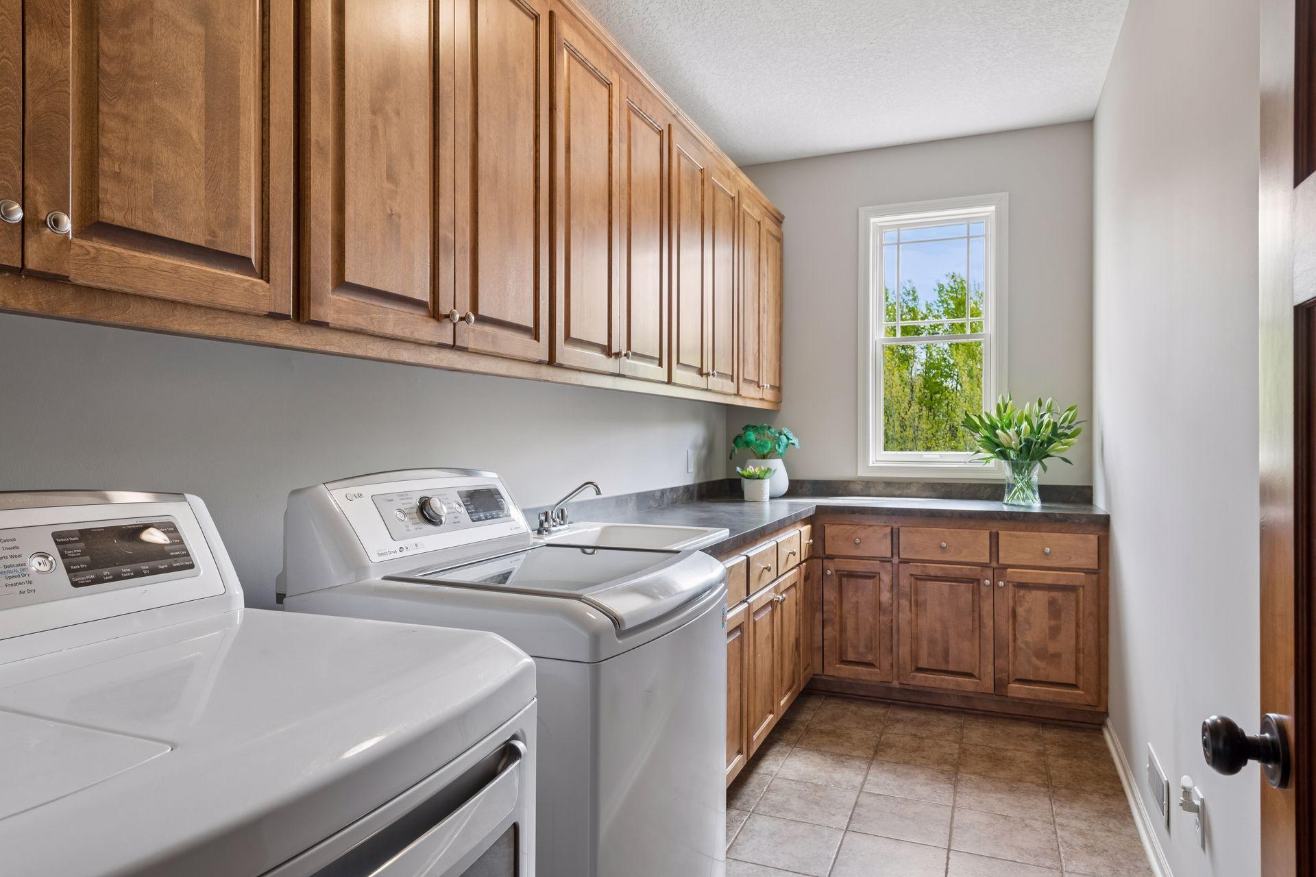 Large main level laundry room with storage and sink