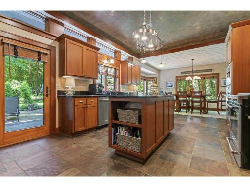 Gorgeous Kitchen. Beautiful Custom Cabinetry and Slate Floors Throughout Most Of The Main Level. Notice the Tray Ceiling and Transom Windows Too!