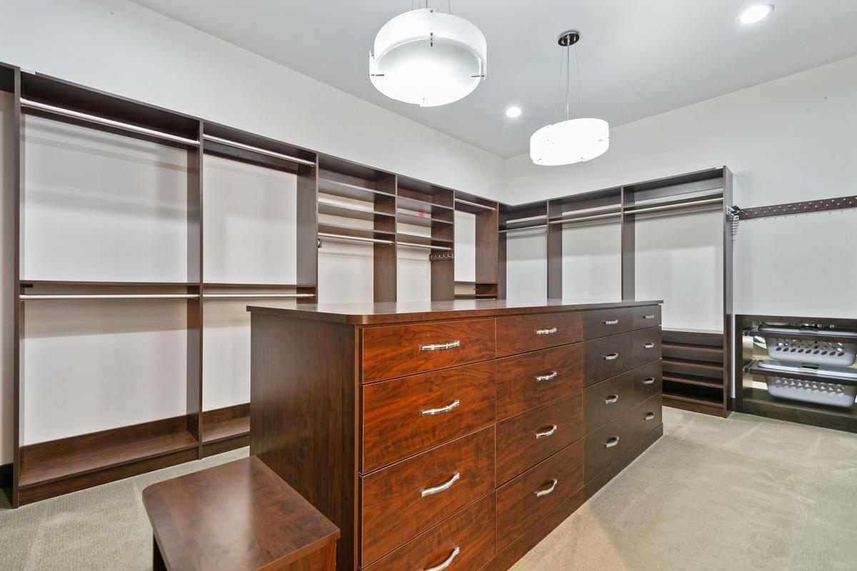 Primary walk in closet - with built in safe and incredible pull outs and storage - see plans!