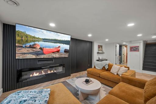 The wood accent wall to the right of the TV is actually a hidden door to the tool room~