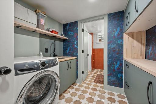 Lower level laundry room with custom cabinetry and 3/4 bathroom with.... you guessed it... heated floors!
