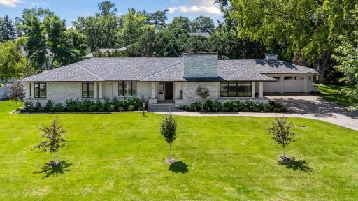 Introducing 14 Woodland Road, located in the sought-after Minnehaha Woods neighborhood of Edina, Minnesota.