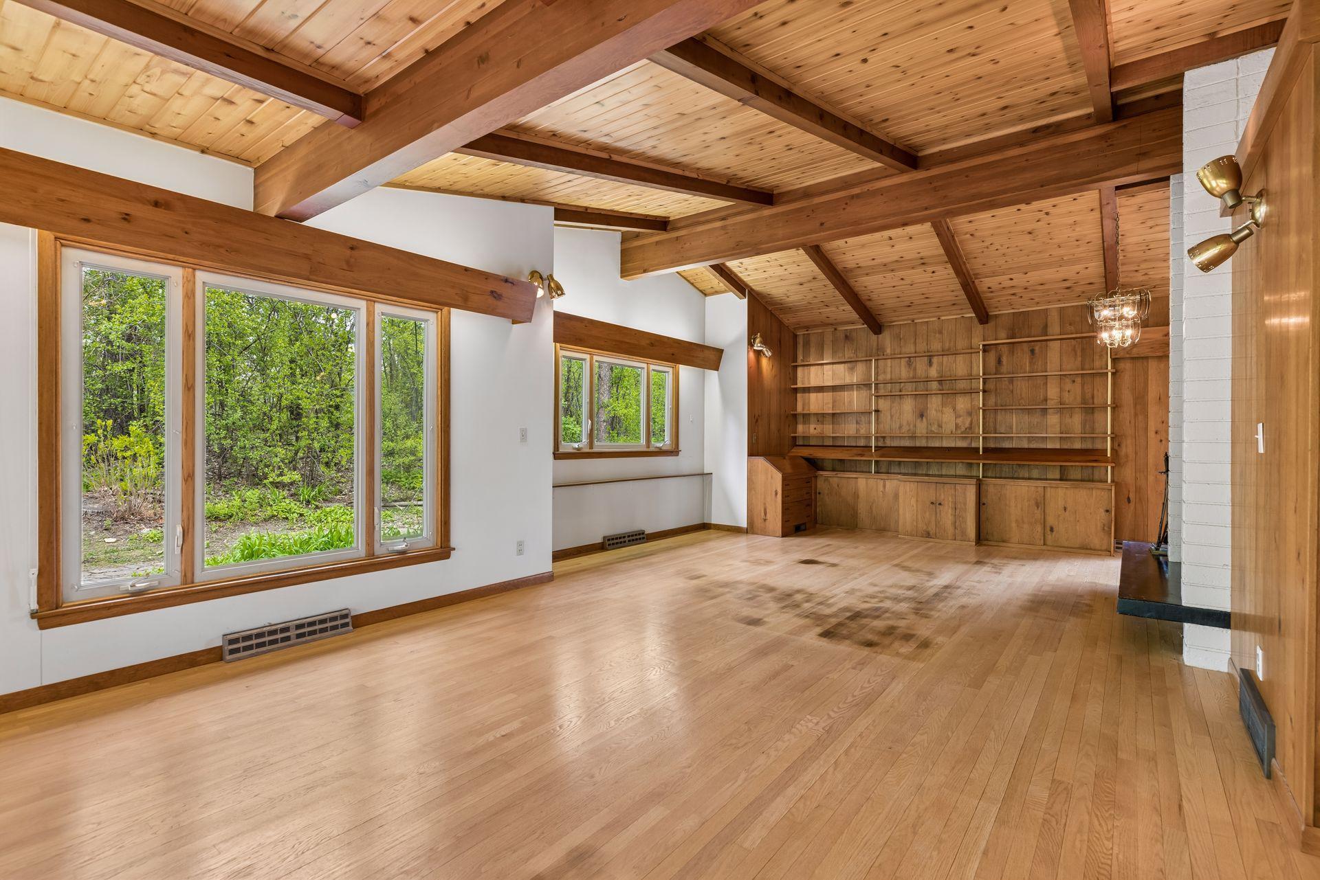 Living room with wood-covered valances for up lighting ceiling detail. Bring your renovation imaginations.